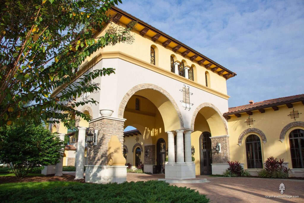 Stone-and-stucco tower entry with tall arches at the Gran Paradiso clubhouse