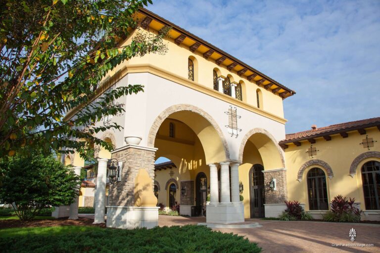 Stone-and-stucco tower entry with tall arches at the Gran Paradiso clubhouse