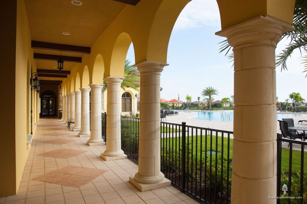 Arched covered walkway with stone columns overlooking the Gran Paradiso resort pool
