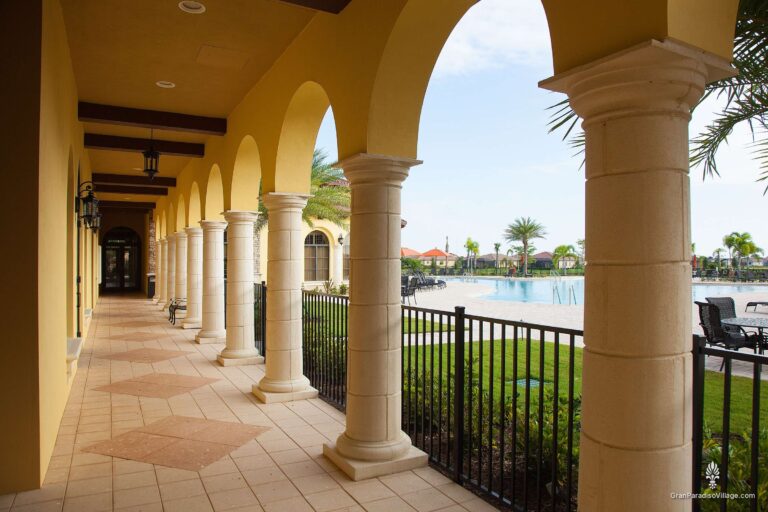 Arched covered walkway with stone columns overlooking the Gran Paradiso resort pool