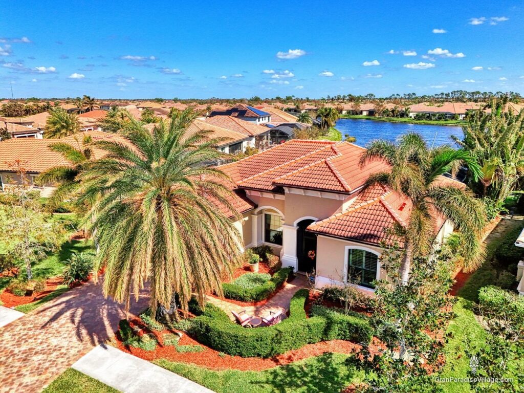 Wellen Park aerial of a tile-roofed Gran Paradiso custom home near a lake