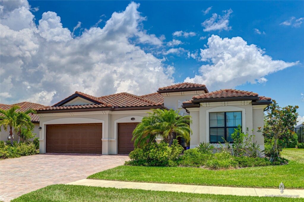 Wellen Park Gran Paradiso manor home with tile roof and wood-tone garage doors