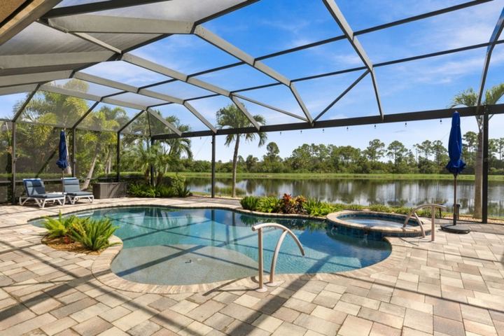 Heated pool and spa with pond and preserve view