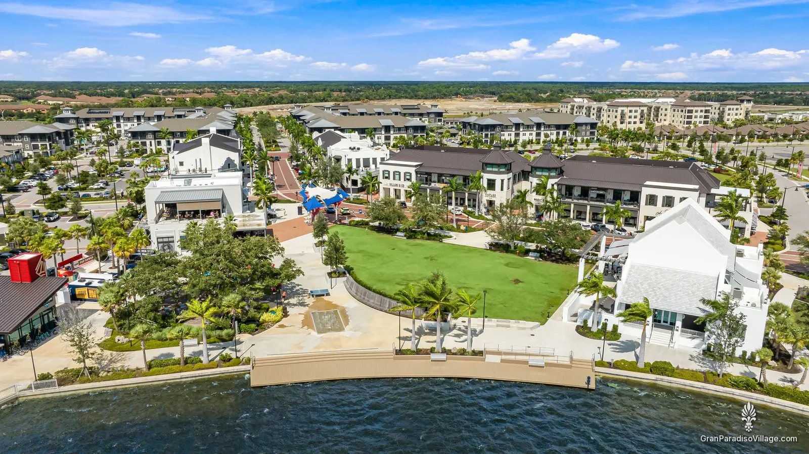 Drone view of the Downtown Wellen lakefront lawn, buildings and Grand Lake on a sunny day