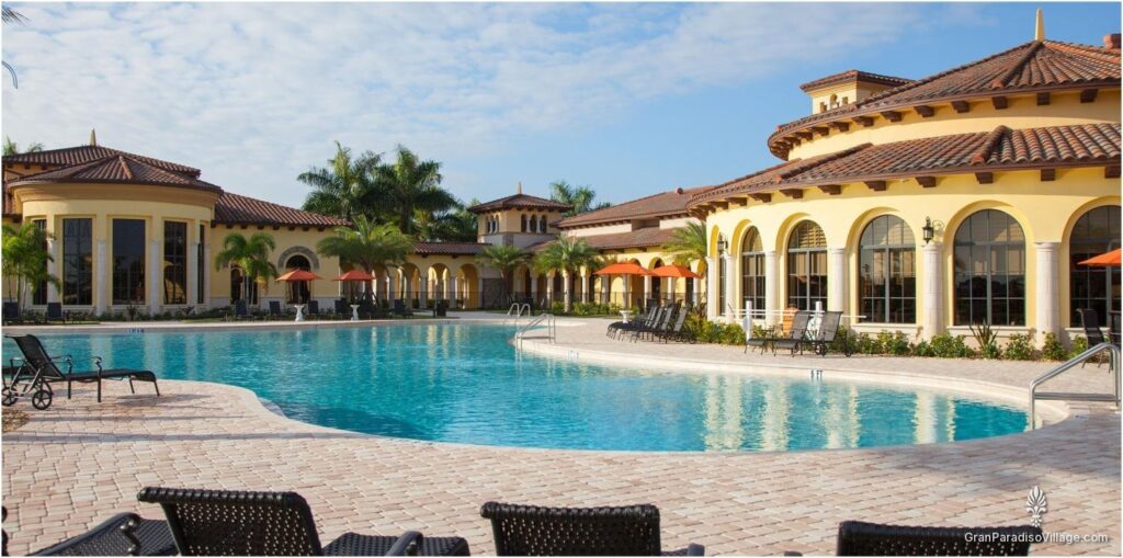 Gran Paradiso clubhouse resort pool with lounge chairs and the clubhouse behind it
