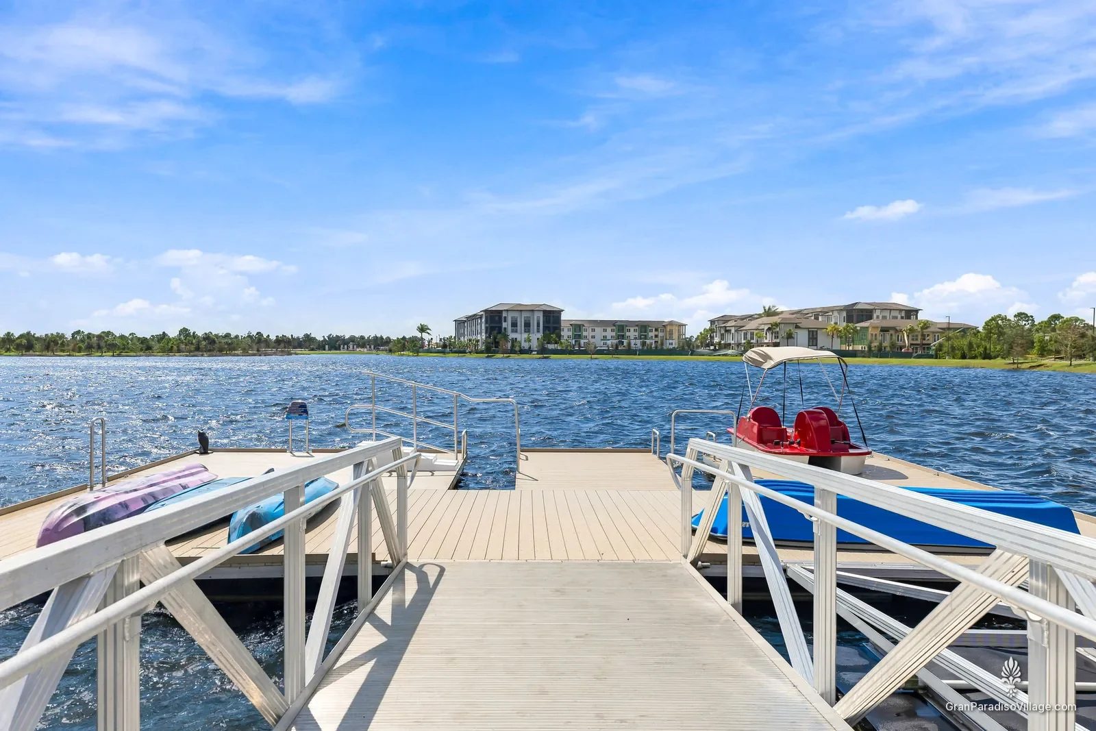Floating dock on the Grand Lake with kayaks and a red pedal boat, Downtown Wellen, Wellen Park