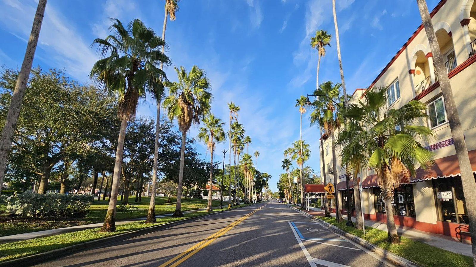 Palm-lined Venice Avenue with Mediterranean Revival storefronts in historic downtown Venice, Florida