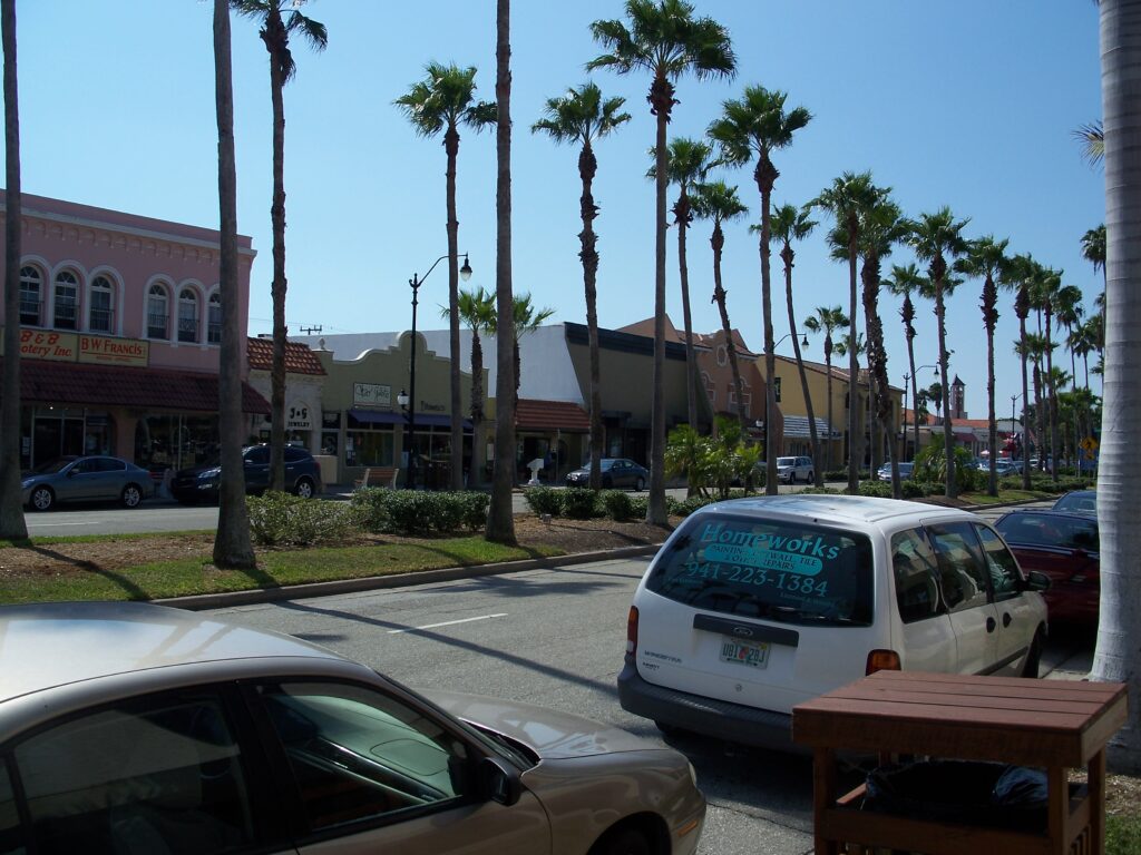 A street in the John Nolen Plan of Venice Historic District with walkable blocks and Mediterranean Revival storefronts